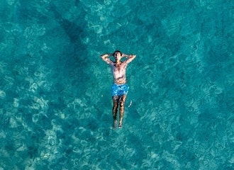 Man floating on the ocean and relaxing