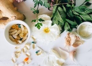Herbs, flowers, ginger and supplements in capsules